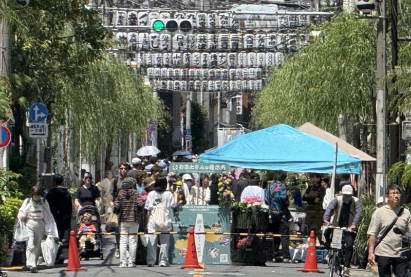 またぎ提灯が連なる柳通りの歩行者天国を歩く人々
